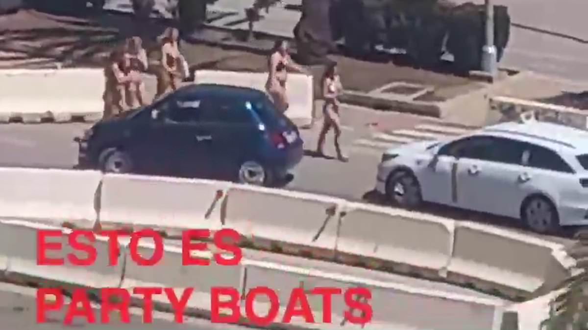 Bikini-clad girls stroll past stunned onlookers after debarking from a party boat in Palma in latest near-naked display to rile locals after tourist went shopping in his Speedos [Video]