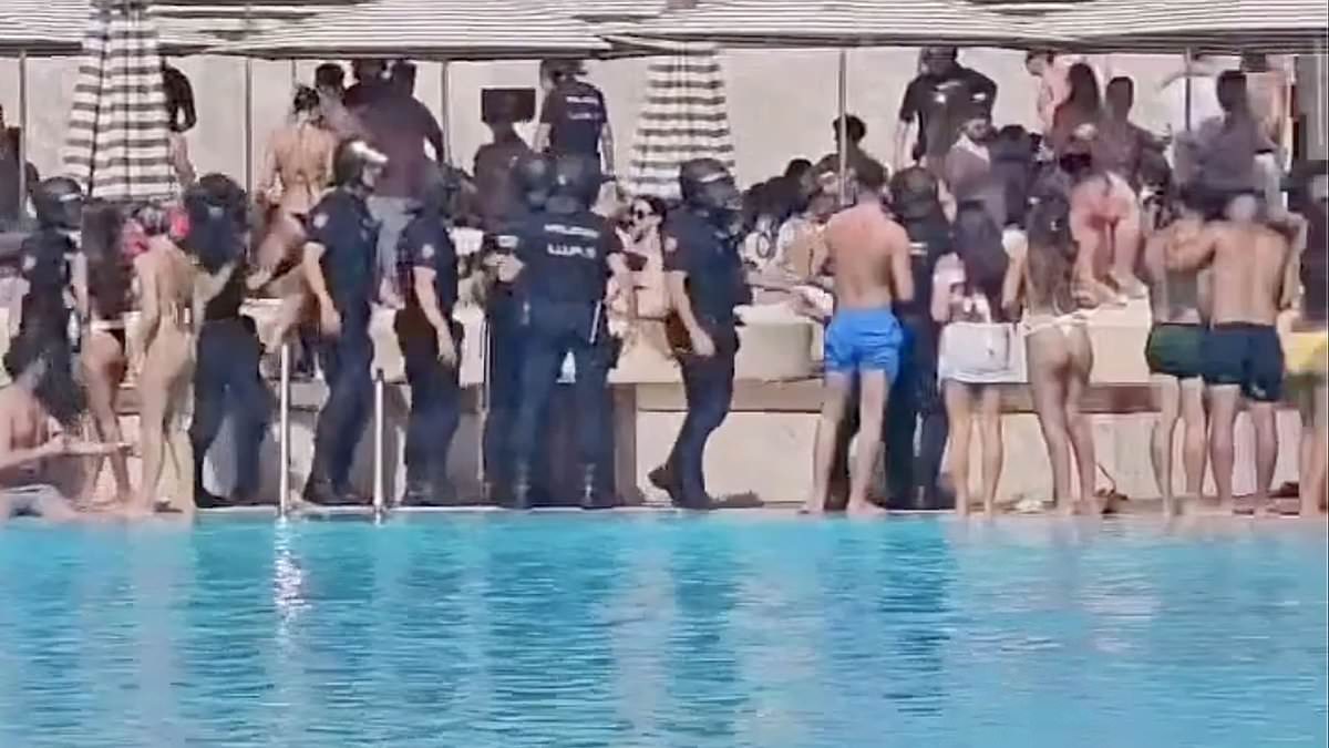 Dramatic moment heavily-armed police storm Marbella beach club and order tourists out of the pool as helicopter circles overhead after spate of violence in the region [Video]