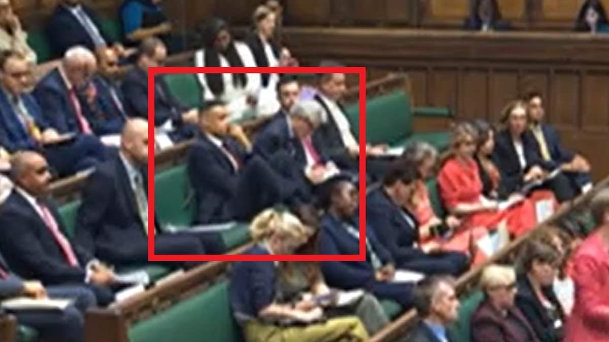 Labour’s Clive Lewis branded ‘disrespectful’ after putting his feet on the furniture in the Commons during King’s Speech debate – having had to take his oath twice after republican protest [Video]